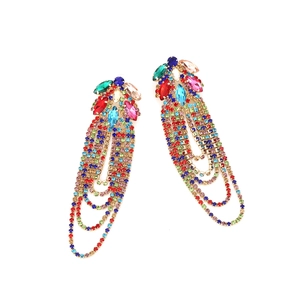 Close-up of colorful rhinestone tassel earrings with multi-layered crystal fringes