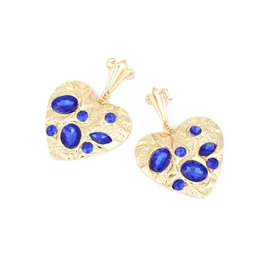 Detail of gold heart drop earrings featuring blue gemstones and ripple textured metal