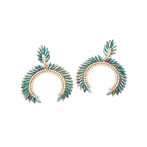 Macro detail of large gold C-shape drop earrings with colorful marquise rhinestones