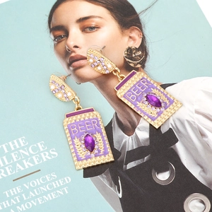 Creative purple enamel beer can earrings with rhinestones and pearls in a stylish display