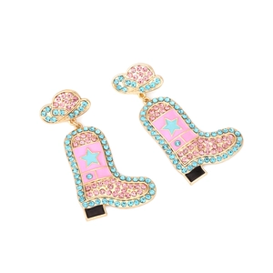 Detail of pink cowboy hat and boot earrings with colorful crystals and star motifs