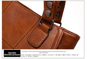 Detailed macro of brown leather handle stitching and gunmetal hardware on handbag