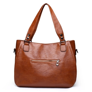Brown faux leather tote bag with stitch detail and front zipper pocket on white background