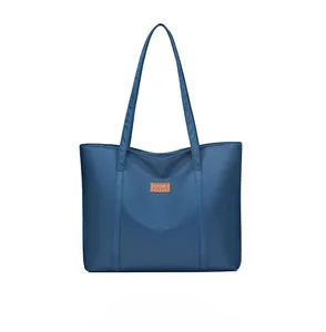 Detail of navy blue nylon tote bag showing durable fabric and faux leather brand patch