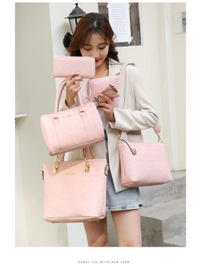 Close-up of pink woven leather 6-piece handbag set including tote and crossbody bags
