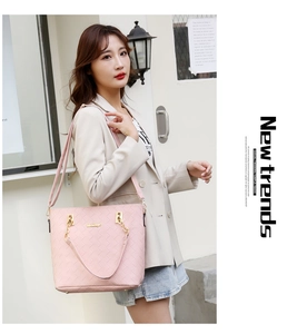 Detail of light pink woven texture on shoulder bag with elegant gold metal chain hardware