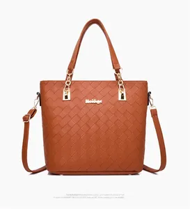 Detailed view of brown woven tote bag with gold Mei&ge logo and adjustable shoulder strap