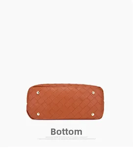 Detailed bottom view of woven caramel leather bag with four protective gold metal feet