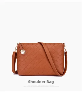 Close-up of brown woven shoulder bag with checkered texture and gold-tone zipper detail