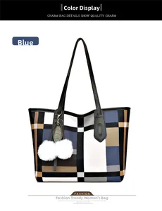 Close-up of Large tote bag featuring blue geometric patchwork and plush ball charm