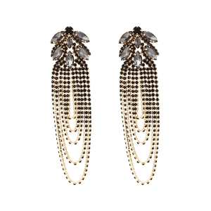 Detailed view of long gold tassel earrings with black rhinestones and marquise crystals