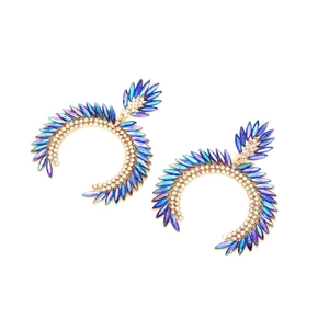 Close-up of gold C-shaped earrings with purple crystal petals and white rhinestones