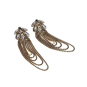 Detailed shot of long rhinestone tassel earrings with gold base and black stones