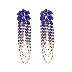 Detail of dark blue crystal tassel earrings with elegant long fringe and golden metal base