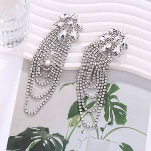 Detail shot of silver tassel earrings featuring marquise-cut rhinestones and cascading chains