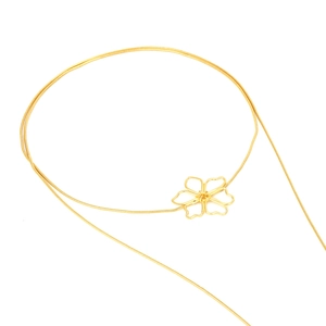 Detailed close-up of a long gold snake chain necklace featuring a minimalist hollow flower pendant