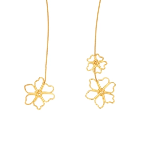 Detailed macro view of gold plated hollow flower pendants on a thin snake chain