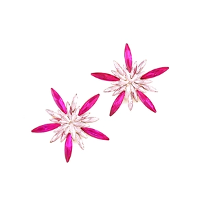 Macro detail of starburst stud earrings featuring pink and fuchsia marquise-cut crystals