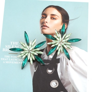 Green crystal floral stud earrings with marquise cut stones in a stylized flower design