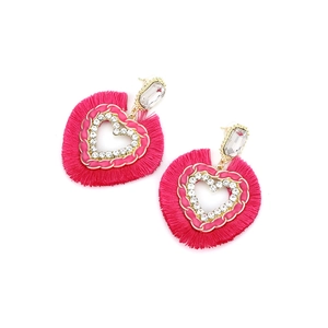 Detailed close-up of hot pink fringe heart earrings with gold trim and rhinestones