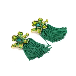 Detail of green enamel flower earrings with silk tassels and sparkling crystals