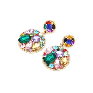 Detailed close-up of geometric hollow round earrings with colorful rhinestones in gold setting