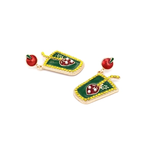 Detail of cute strawberry drink earrings featuring red apple studs and rhinestone accents