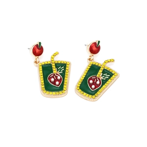 Detail of creative apple and strawberry juice cup earrings with colorful rhinestones