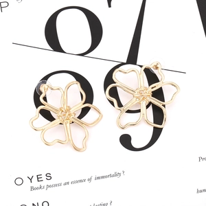 Minimalist gold flower stud earrings featuring a hollow five-petal design in golden alloy