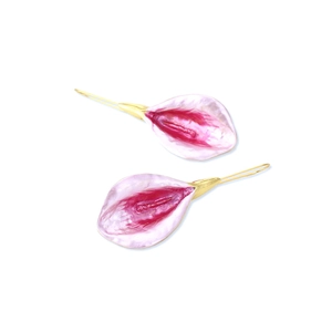 Macro detail of alloy flower drop earrings with pink pearlized enamel and gold hooks