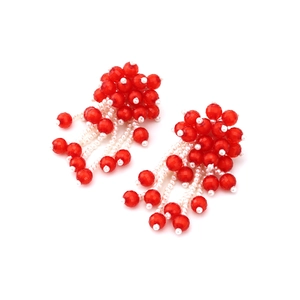 Detailed view of red and white handmade beaded tassel earrings with floral cluster design