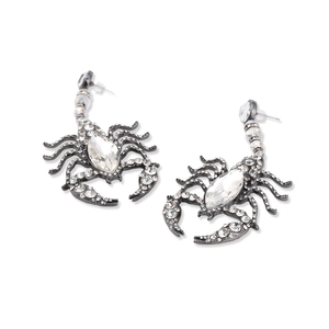 Macro shot of silver scorpion earrings with crystal rhinestones and gothic alloy base
