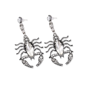 Close-up of gothic scorpion earrings with sparkling rhinestones and marquise stones
