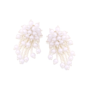 Detailed view of handmade white beaded fringe earrings with delicate floral clusters