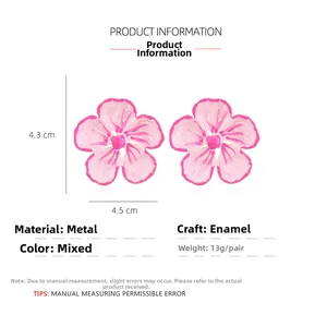 Macro shot of gradient pink flower earrings with detailed oil-dripped metal petals
