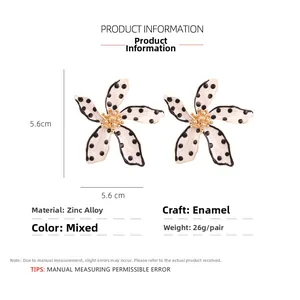 Detail showing 5.6cm floral earrings with cream base and black polka dots in zinc alloy