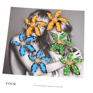 Floral polka dot enamel earrings in orange, blue, and green with golden centers
