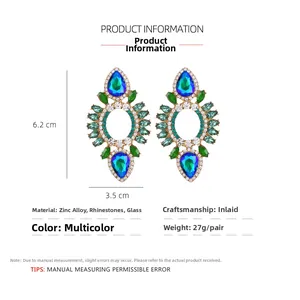 Macro view of geometric drop earrings with blue glass stones and sizing of 6.2cm by 3.5cm