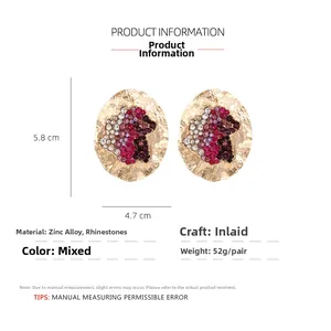 Detailed view of oversized irregular oval earrings with colorful rhinestones and gold texture