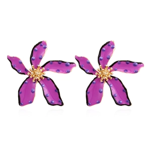 Detailed view of purple floral earrings with blue polka dots and golden stamen centers