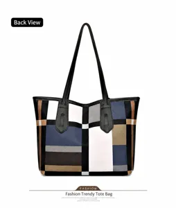 Rear view of a geometric color-block tote bag with minimalist navy and brown leather panels