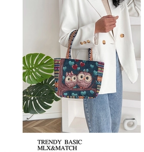Close-up of owl jacquard embroidery detail on a boho canvas tote bag with woven straps