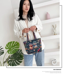 Detail of owl embroidery and colorful striped straps on a canvas ethnic tote bag
