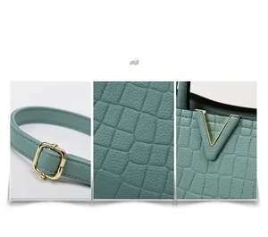 Detail showing mint green crocodile embossed leather texture and gold hardware on the bag