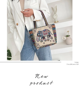 Close-up of vibrant elephant and floral embroidery on a sturdy canvas tote bag