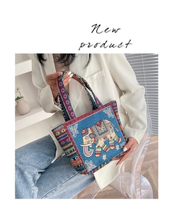 Ethnic blue canvas tote bag with detailed elephant embroidery and striped woven handles