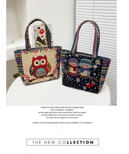 Detailed view of woven tote bag with intricate owl pattern embroidery and striped handles