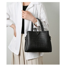 Detailed view of crocodile pattern faux leather tote with golden V logo and D-ring