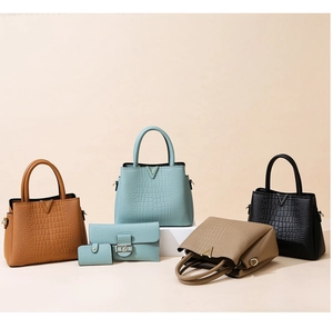 Set of embossed crocodile pattern handbags and matching wallets with gold V-shaped logos