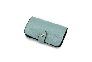 Detail of mint green lychee pattern wallet with a golden metal snap button closure